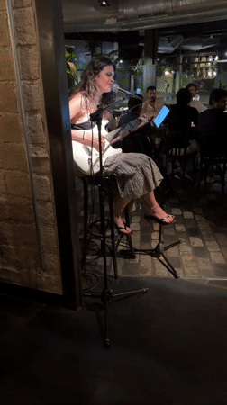 Solo electric guitar performance against a brick wall in Barcelona