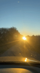 Driver records rural road journey through windshield