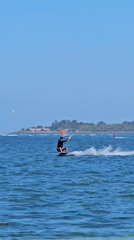 Kitesurfing session in blue waters off Denpasar coast