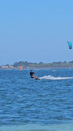 Kitesurfing session in blue waters off Denpasar coast