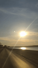 Sunset documented over water in Chaikovsky, Russia