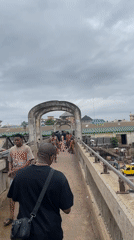 Pedestrian crosses busy urban bridge in Onitsha, Nigeria