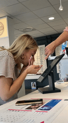 Woman struggles with contact lenses at optician in Saint-Galmier