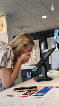 Woman struggles with contact lenses at optician in Saint-Galmier