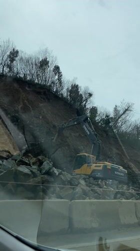 Excavator breaks rocks at Montenegro construction site