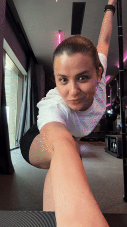 Woman stretches at gym bar in Tivat Montenegro