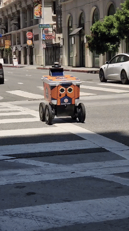 Downtown LA street life: delivery robots, rooftop work, and city views