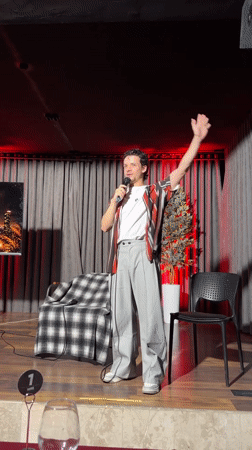 Man delivers speech on stage in Tashkent