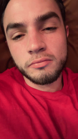 Man rests on sofa, gives thumbs up in Mexican home