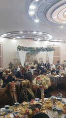 Indoor wedding reception with ceremony, music, and guests