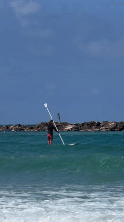Beach-goers enjoy morning water activities along Tel Aviv coast