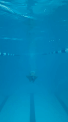 Underwater swim session in a clear blue pool, Gornozavodsk