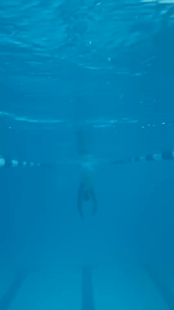 Underwater swim session in a clear blue pool, Gornozavodsk