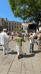 Folk dancers and street musicians perform in Barcelona's Gothic Quarter