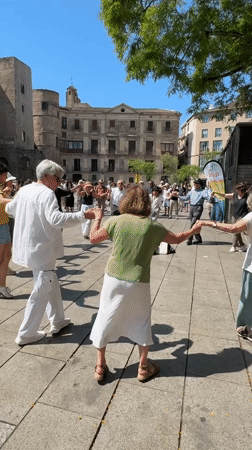 Folk dancers and street musicians perform in Barcelona's Gothic Quarter