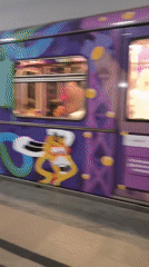 Decorated subway train departs historic station with gold 1946 relief