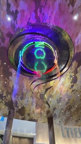 Circular indoor waterfall with colorful LED lighting in Bangkok