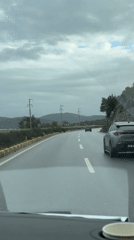 Wet highway drive through Turkish hills under grey skies