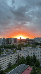 Dramatic sunset with storm clouds observed across city skyline