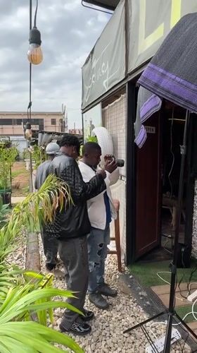 Photoshoot documented outside building in Bar Jirgi Summa, Nigeria