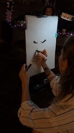 Caricature artist at work on Belgrade pedestrian street at night