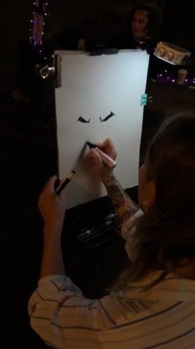 Caricature artist at work on Belgrade pedestrian street at night