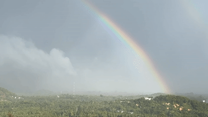 Double rainbow appears over misty Koh Phangan landscape