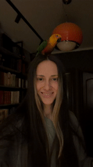 Woman plays with colorful parrots at Khimki home