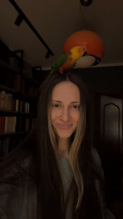 Woman plays with colorful parrots at Khimki home