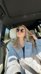 Woman drives on highway during sunny morning commute