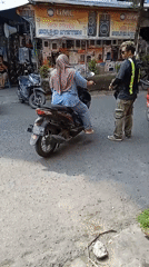 Morning street activity outside Banjarmasin shops and motorcycle rows