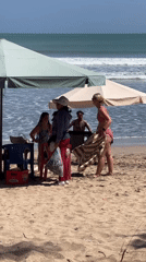 Busy afternoon on Kuta Beach with surfers and sunbathers