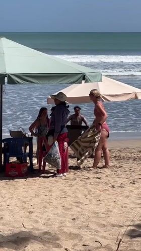 Busy afternoon on Kuta Beach with surfers and sunbathers