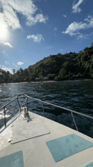 Boat approaches tropical beach in Banjar, Indonesia