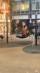 Tire swing moment in Barcelona, mural backdrop