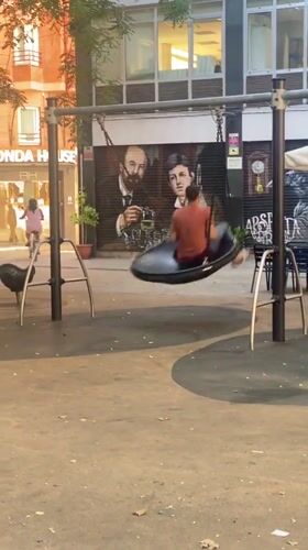 Tire swing moment in Barcelona, mural backdrop