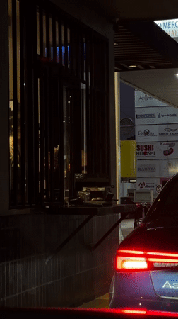 Night drive-thru transaction captured in Tlaxcalancingo, Mexico