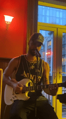 Street musician performs with electric guitar in London