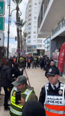 Police gather with crowds outside Tangier hotel amid public event