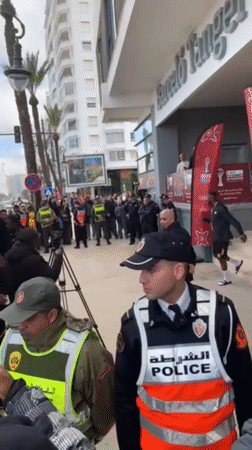 Police gather with crowds outside Tangier hotel amid public event