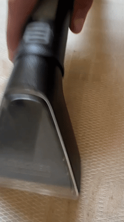 Person Uses Upholstery Cleaner on Textured Surface in Bulgaria