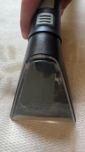 Person Uses Upholstery Cleaner on Textured Surface in Bulgaria