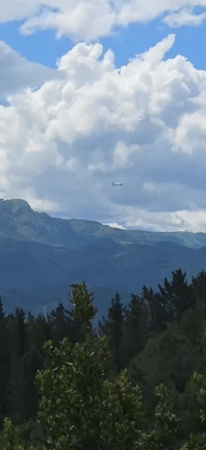 Aircraft spotted over Hondarribia's green mountains and cityscape