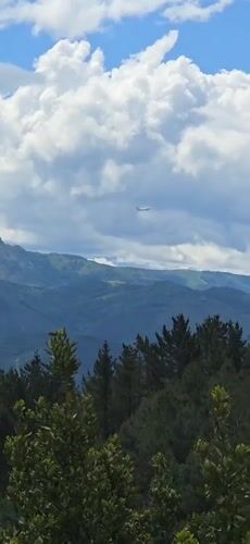 Aircraft spotted over Hondarribia's green mountains and cityscape