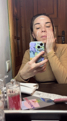 Woman records skincare routine selfie video in mirror