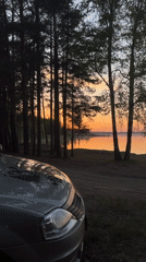 Car parked by lake during sunset captured in Chaikovsky