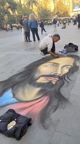 Street artist draws Jesus portrait near Santiago cathedral