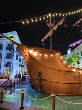 Nha Trang beachfront at night: sculptures, pirate ship, and beach bars