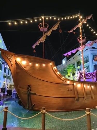 Nha Trang beachfront at night: sculptures, pirate ship, and beach bars