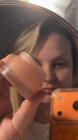 Skincare routine with pink dropper bottle, Tel Aviv bathroom